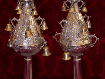 Two silver finials with bells. 