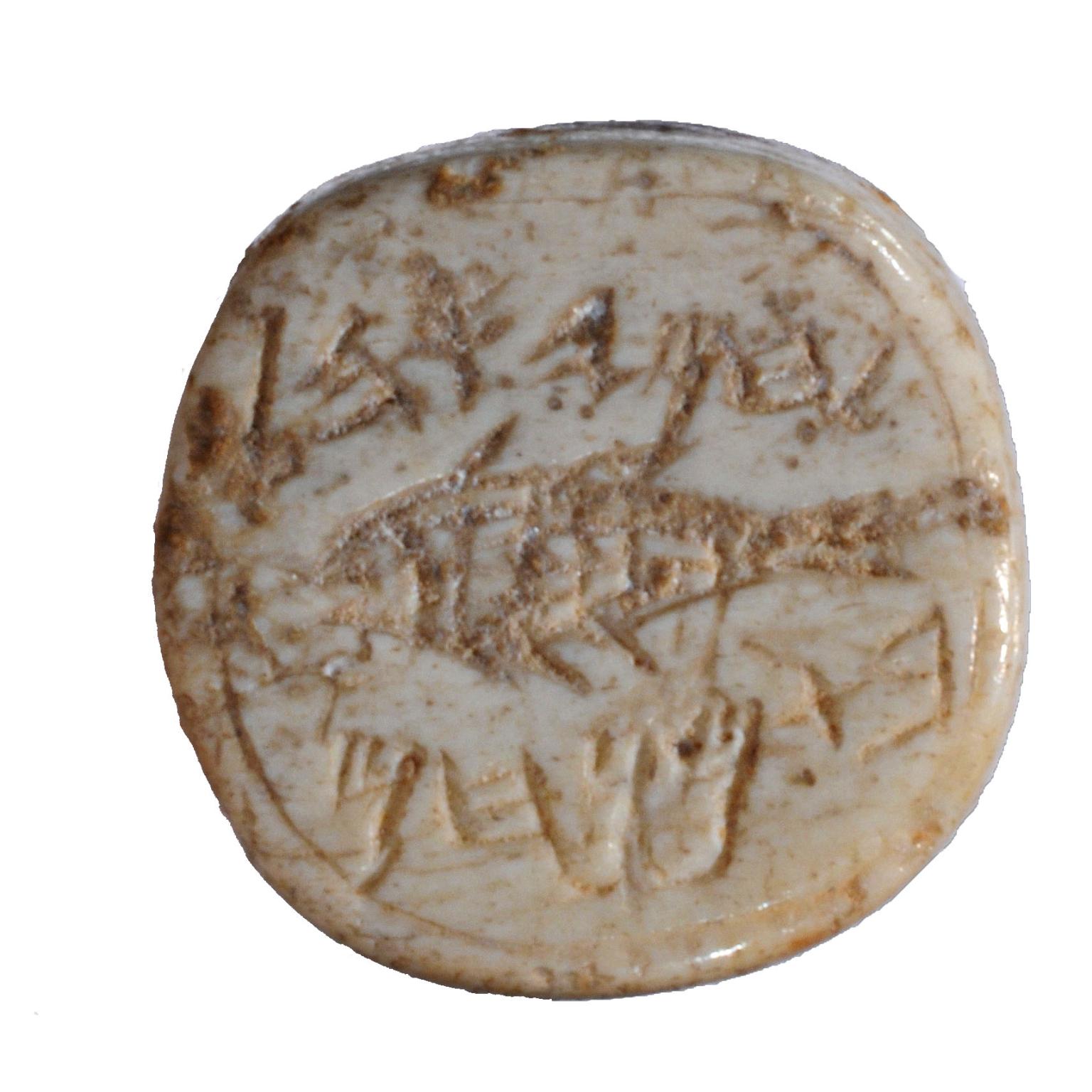 Seal made of bone and decorated with a fish and a Hebrew inscription.
