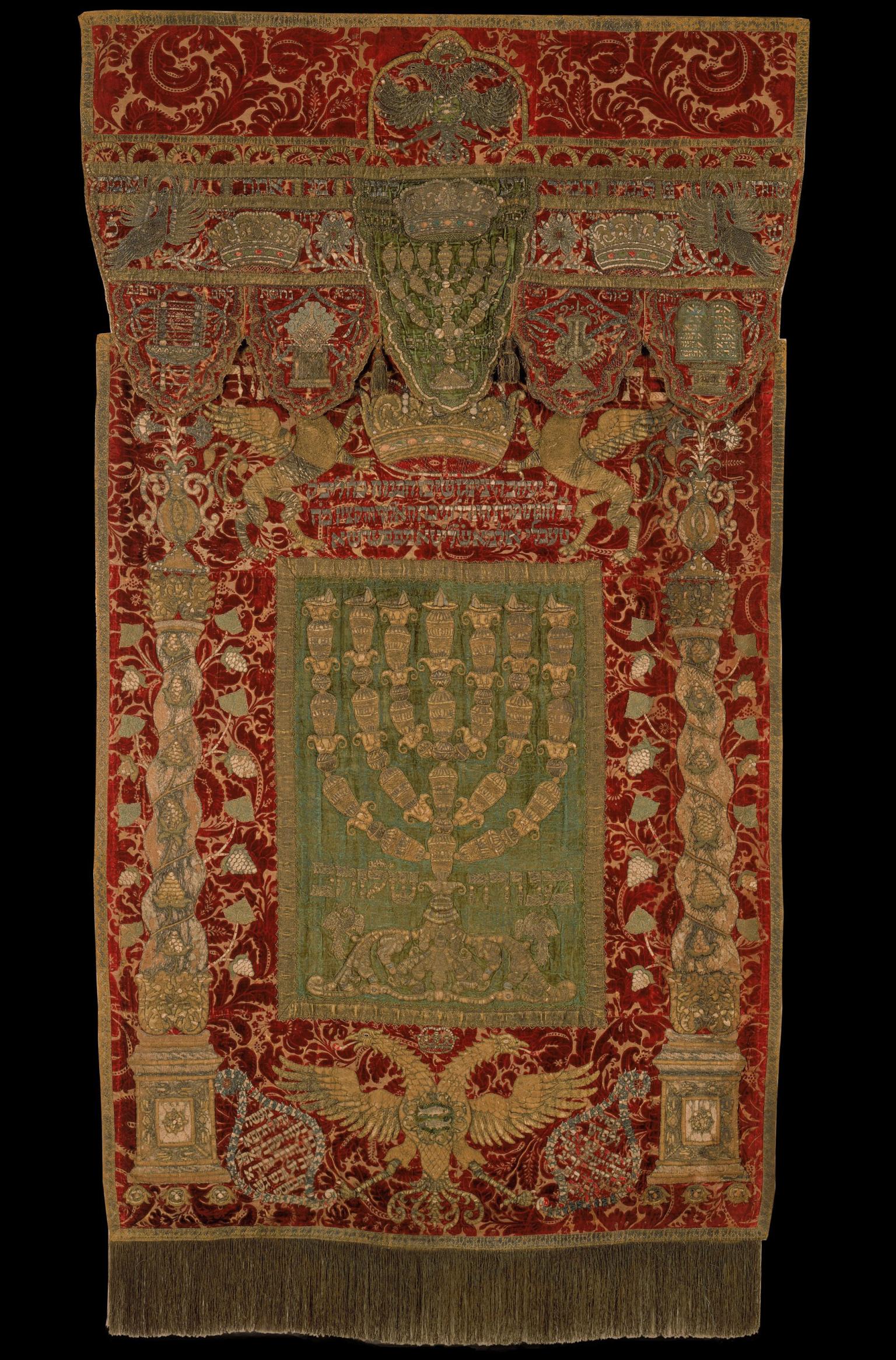 Embroidered curtain and valence bearing three crowns and five vessels.