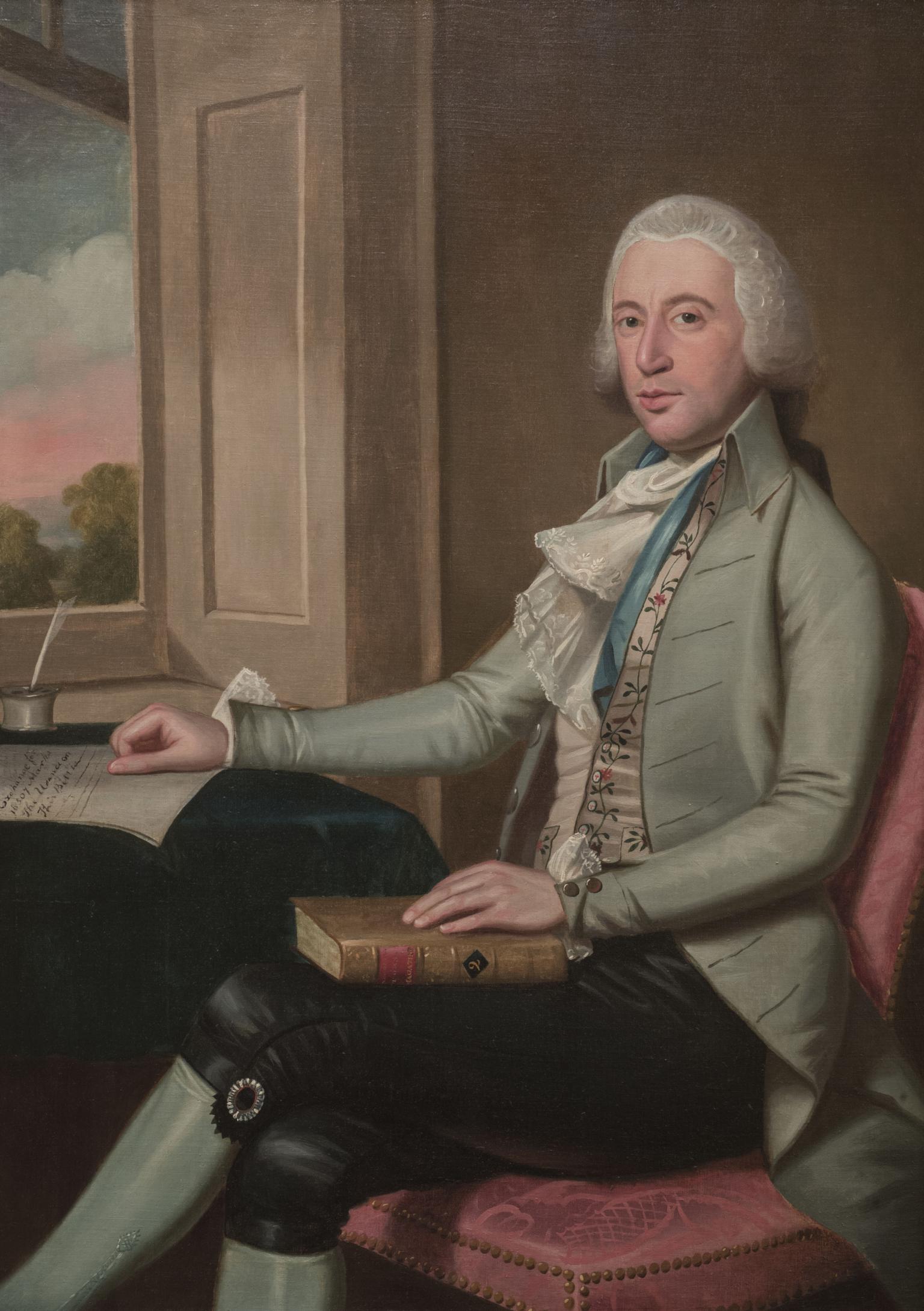 Portrait painting of man seated at desk in front of an open window, facing viewer and holding a book in his lap with his right hand on desk.