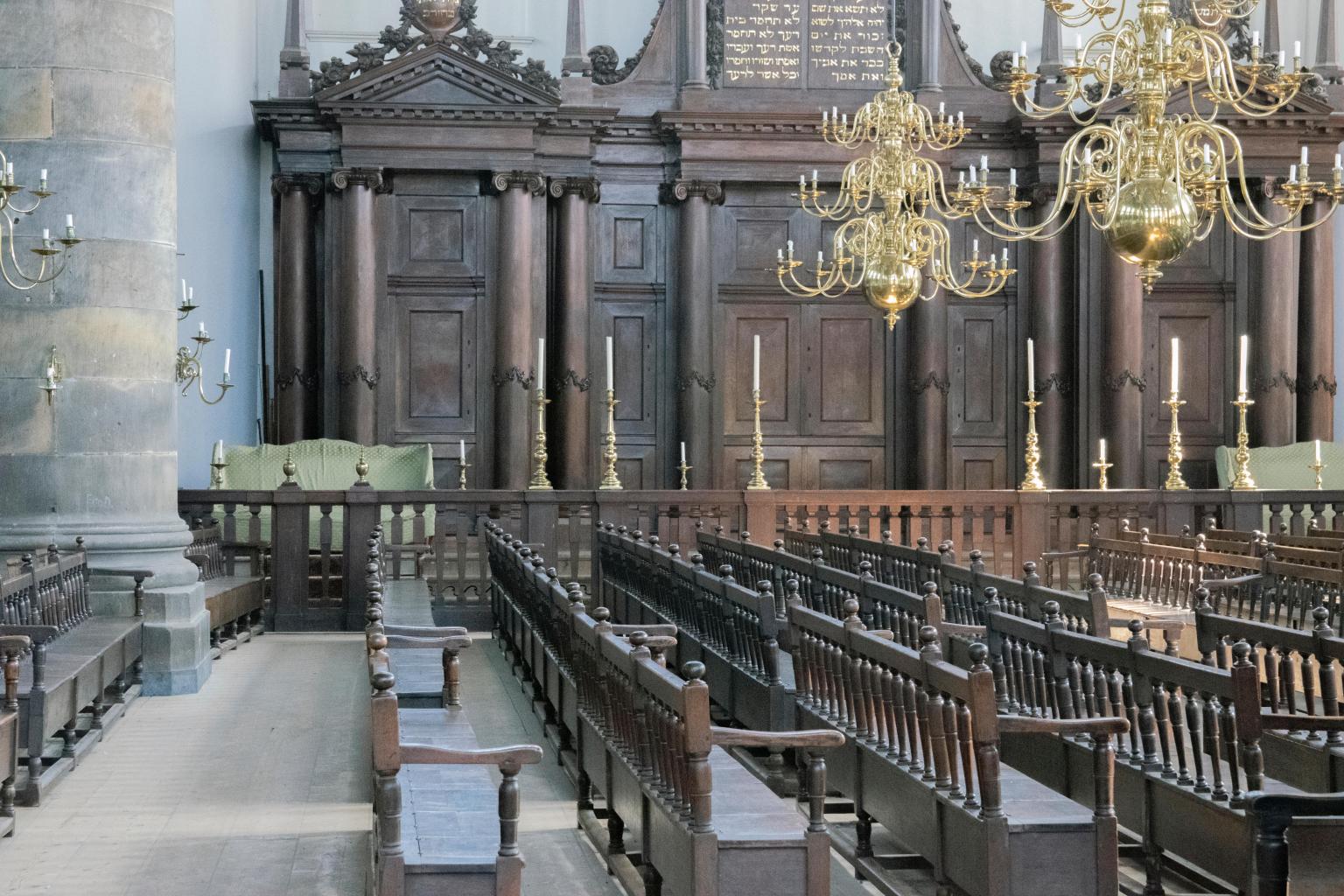 Photograph of room with wooden pews.