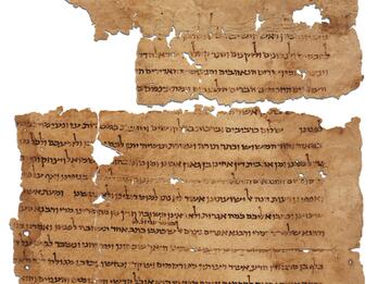 Torn parchment page in two pieces with Hebrew writing, with a clay seal at the bottom right corner.