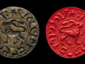 Round bronze seal with image of a lion encircled by reversed Hebrew script, next to a red wax seal impression of same.