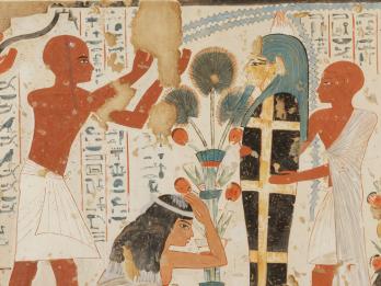 Mural of crouching woman with hand on her head next to upright mummy held up by figure in tunic, as another figure in tunic raises arms above woman, with hieroglyphic text in background. 