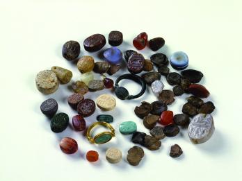 Inscribed seals of various sizes and shapes, mostly made of semi-precious stone, including two that are set in rings.