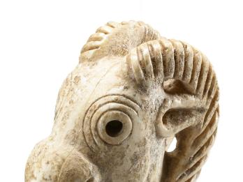 Ivory stopper in shape of ibex head with open mouth.