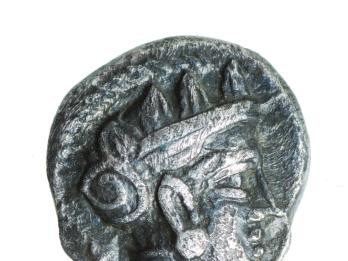 Coin with image of head wearing helmet.