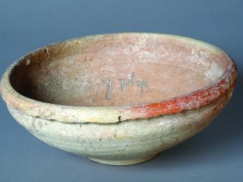Ceramic bowl with Hebrew word inscribed inside.
