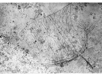 A faint, ancient wall drawing shows a simple sailboat with a large sail, visible lines suggesting rigging, and a textured, weathered surface around the sketch.