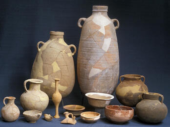 Collection of pottery jars, jugs, and containers, with some missing pieces.
