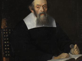 Portrait painting of man in robes with collar facing viewer and sitting at a desk, his hands resting on an open book and holding glasses in his left hand. 