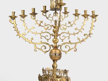 Nine-branched candelabrum with small carved eagle on top and crown shape on base. 