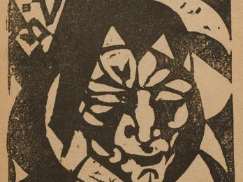 Woodcut of geometric, stylized face with Yiddish heading. 
