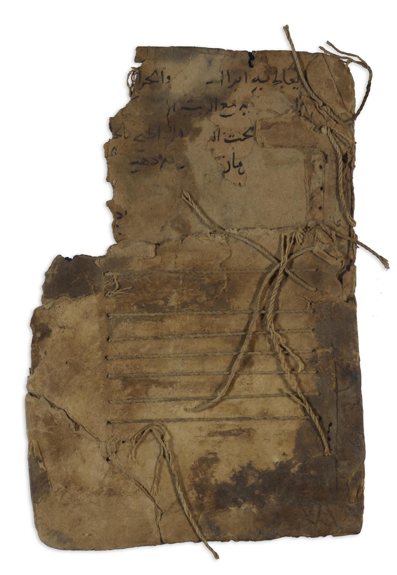Worn, thick sheet of paper with Arabic script toward the top and string below woven through, creating parallel lines.
