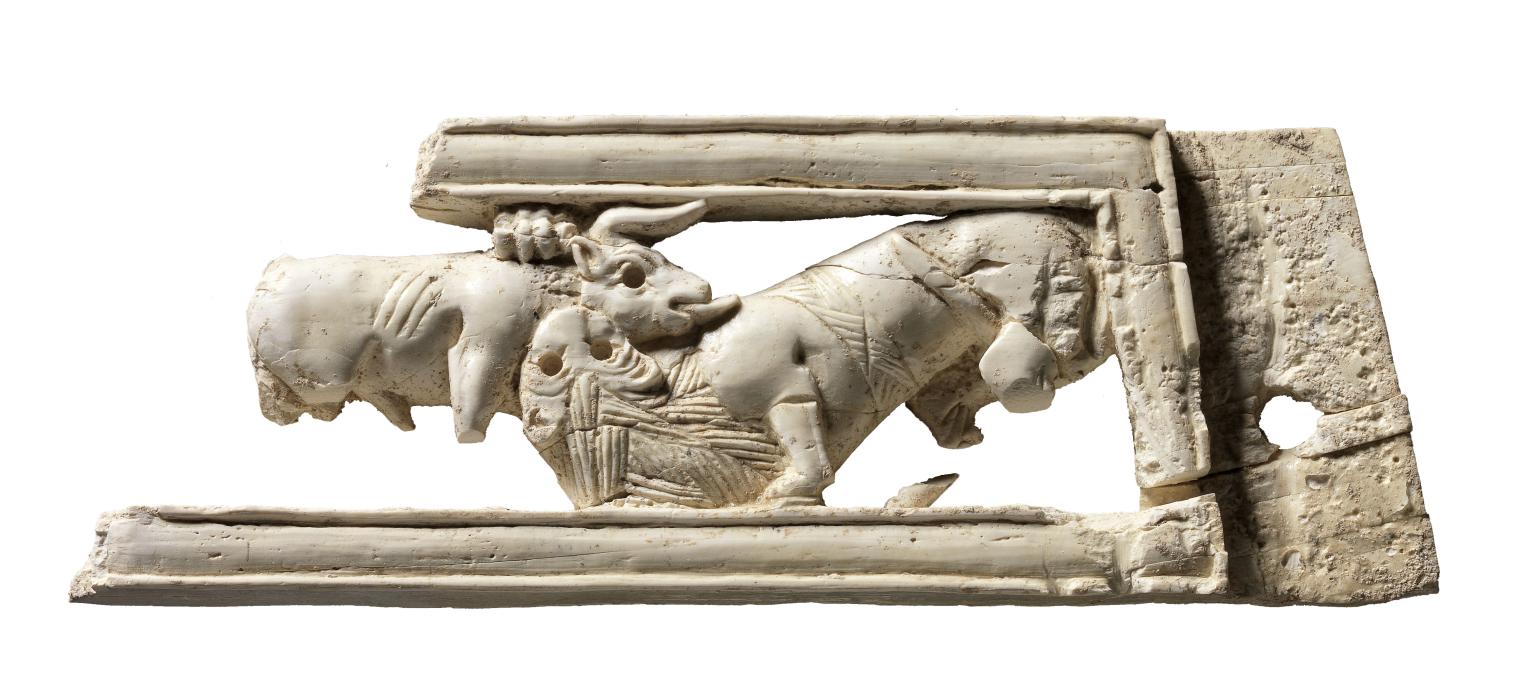 Ivory carving of a sphinx amid lotus flowers.