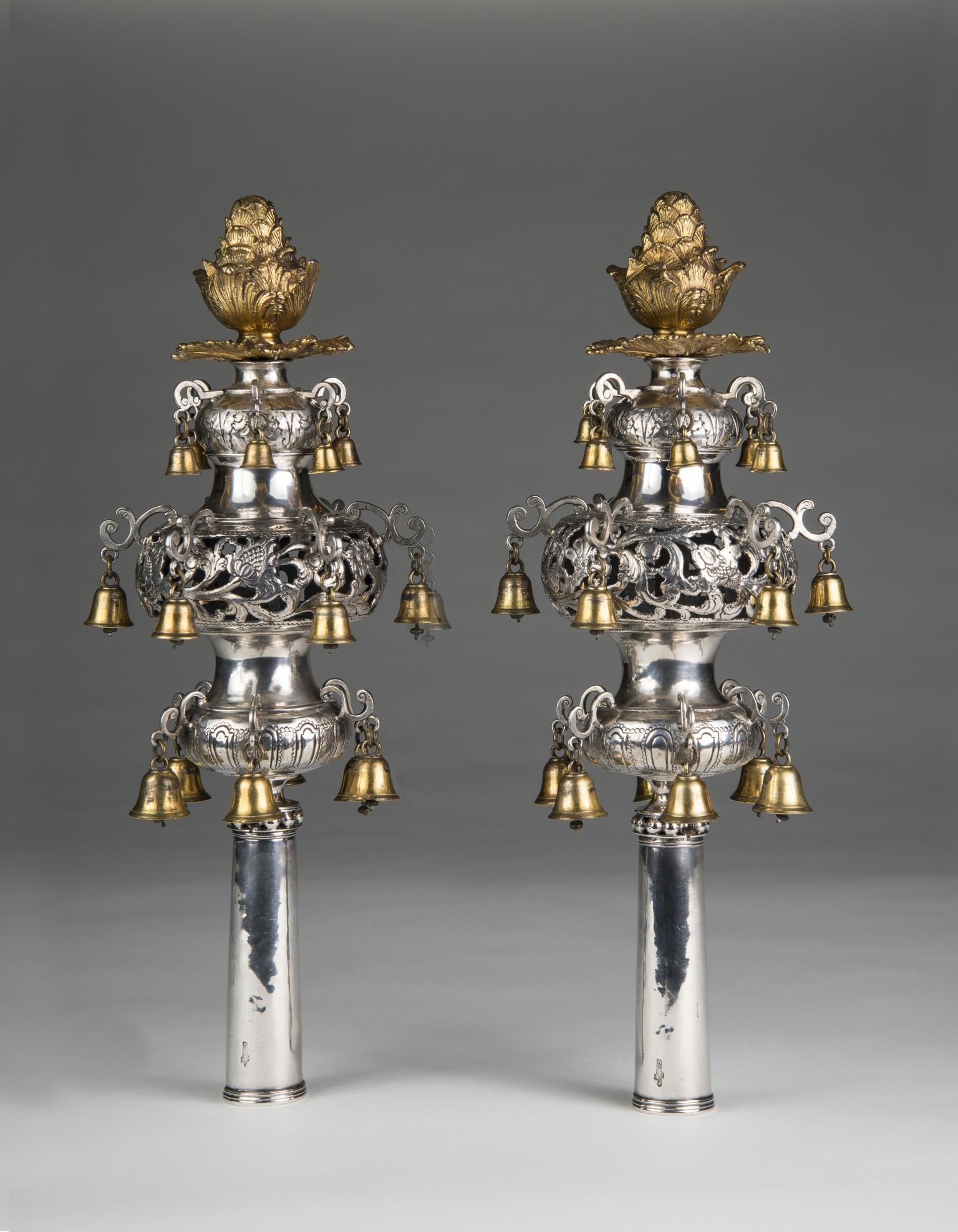 Pair of silver Torah finials with crowns on top.