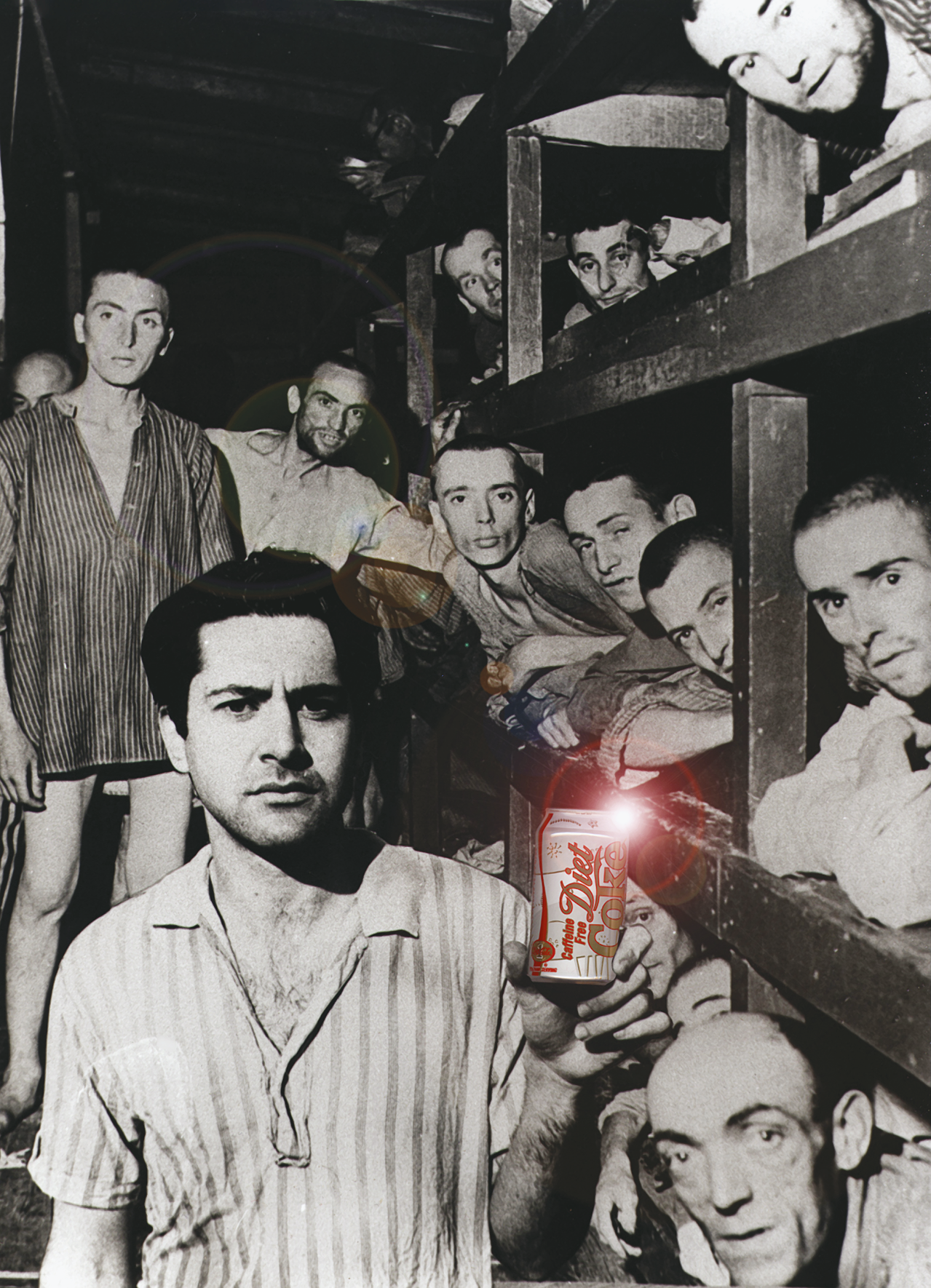 Photograph of men standing and sitting in bunks wearing striped shirts and looking at camera. The one closest to the camera holds a Diet Coke. 