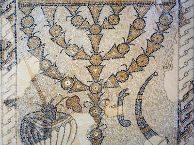 Ancient mosaic showing a large menorah with curved branches, flanked by ritual objects, including a shofar and bowl, with Greek inscriptions above and a decorative border.