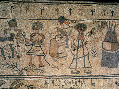 Ancient mosaic with several human figures, including two standing with a donkey on the left and one holding a knife and an infant next to a large fire on the right. In the center is a ram attached to a plant. The mosaic includes Hebrew and Greek inscriptions.