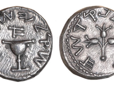 Two sides of an ancient silver coin: one side has a chalice surrounded by Paleo-Hebrew writing, and the other side has pomegranate branches surrounded by Paleo-Hebrew writing.