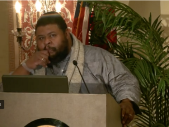 speaker standing at lecturn