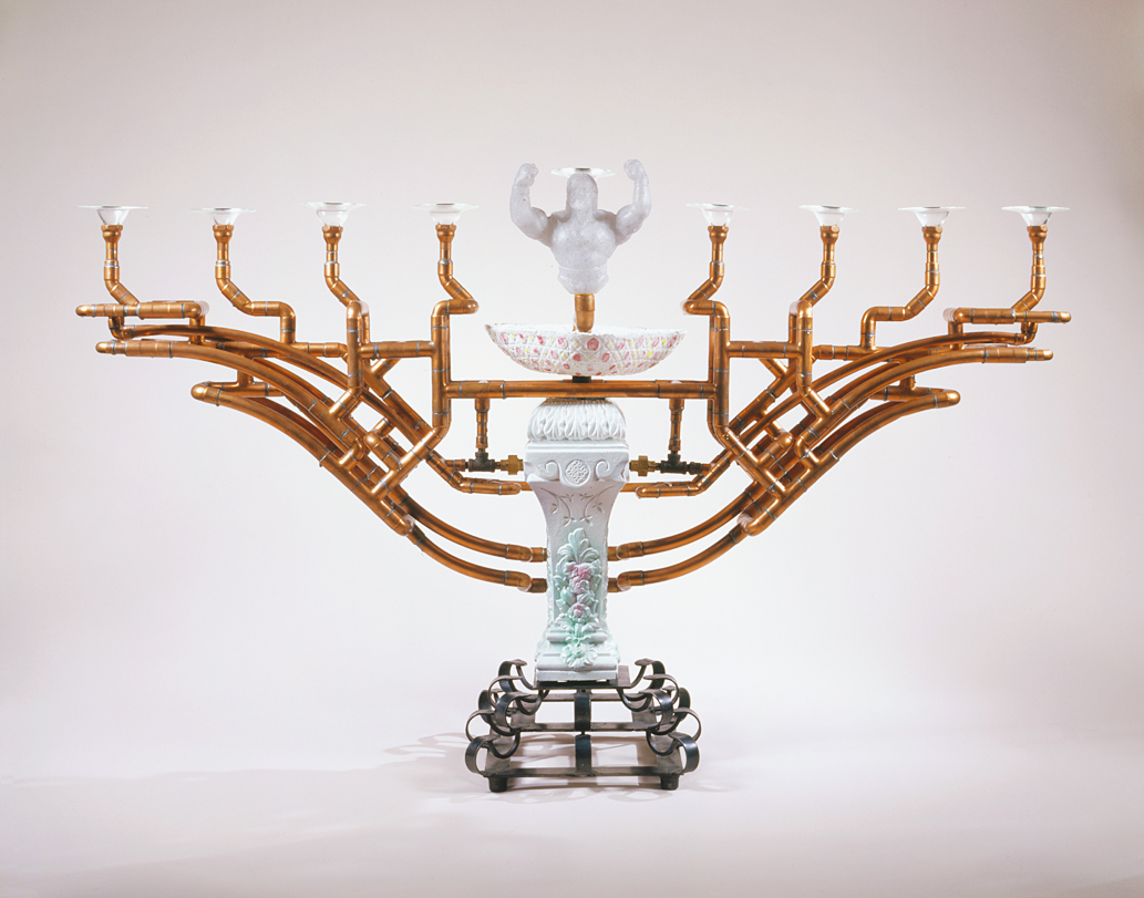 Ceramic menorah with eight copper branches and torso sculpture for center candle. 