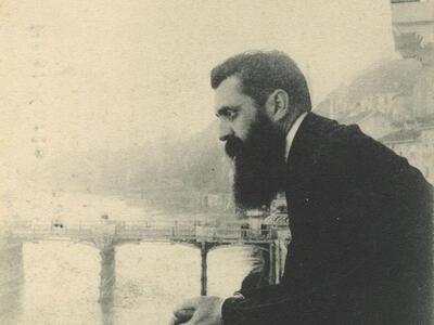 Photograph of man leaning over a bridge.