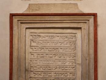 Wood-framed Hebrew inscription.