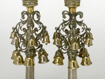 Pair of finials with crowns of bells on branches.