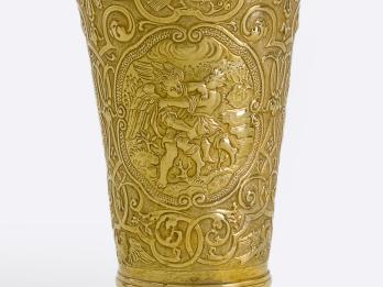 Goblet inscribed with angels, birds, and other animals with a floral motif, and Hebrew text across the lip. 