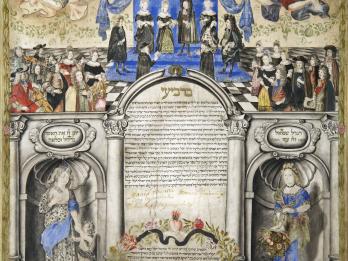Page of Aramaic text surrounded by ornate illustrations, including couple under wedding canopy at the top of the page with many well-dressed people around them and two angels flying overhead, and two women on pedestals on either side of the bottom of the page on either side of a wreath with text inside. 