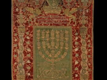 Embroidered curtain and valence bearing three crowns and five vessels.