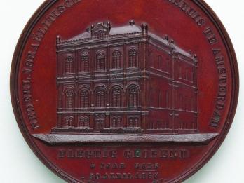 Medal depicting building.