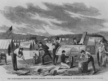 Drawing depicting men building vehicle at a campsite and English caption.