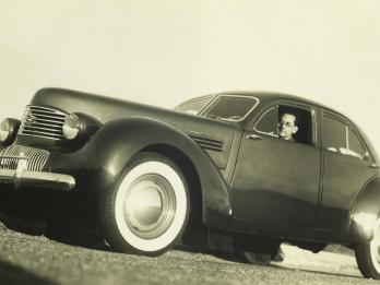 Low angle photograph of a man inside a car. 