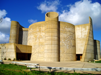 External facade of building with cylindrical and open curved walls. 