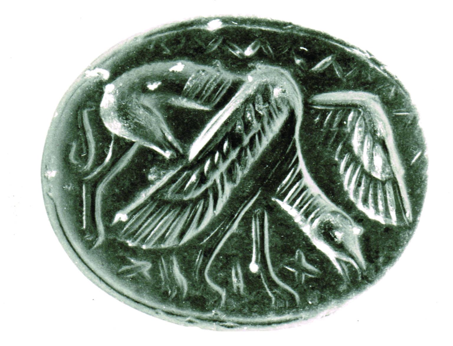 Stone seal decorated with grazing griffin with partially spread wings and bovine body.