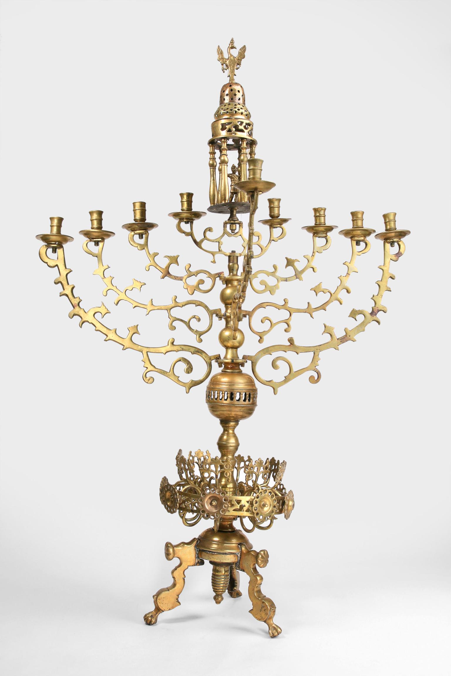 Nine-branched candelabrum with small carved eagle on top and crown shape on base. 