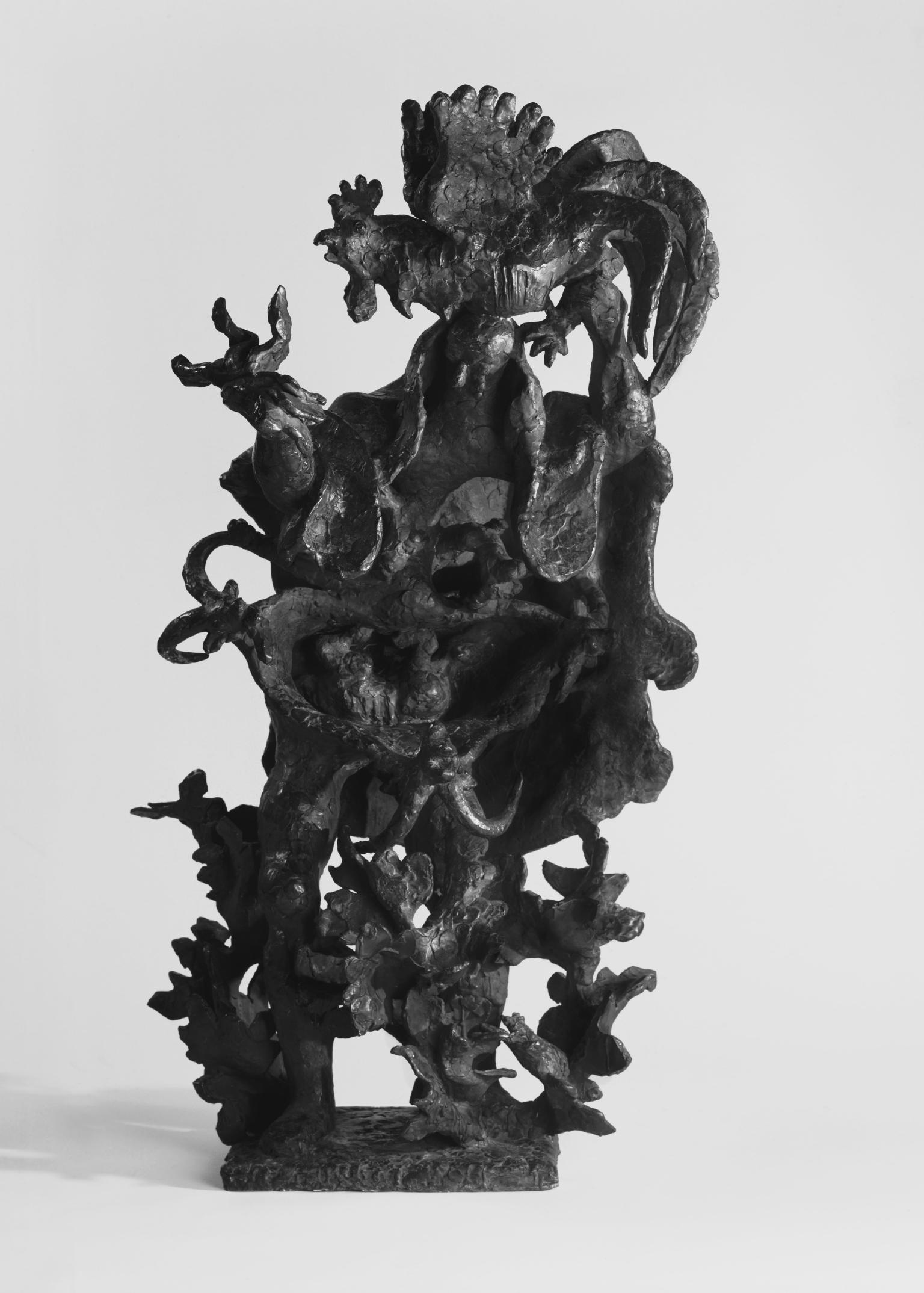 Bronze sculpture depicting a standing man, surrounded by harsh foliage and holding a rooster above his head. 