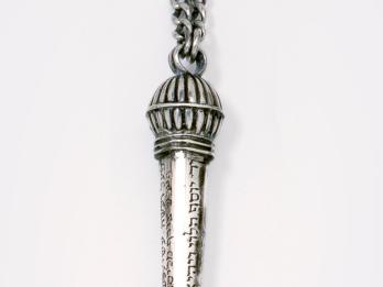 Object with hook and Hebrew imprinted along decorative handle. 