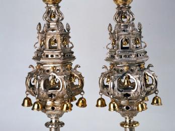Pair of finials with decorated tiers and bells.