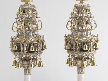 Finials with many layers of branches with bells and topped with crowns.