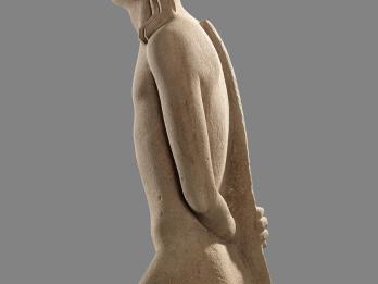 Sandstone sculpture of the upper torso of a naked man with animal features and a bow along his backbone. 