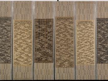 Six vertical tapestries woven in patterns in similar shades.