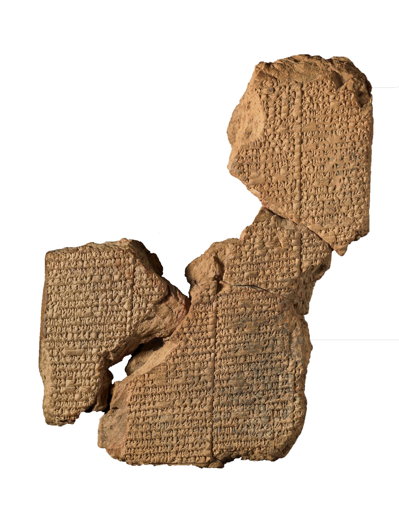 Clay tablet in several sections inscribed with Akkadian text.