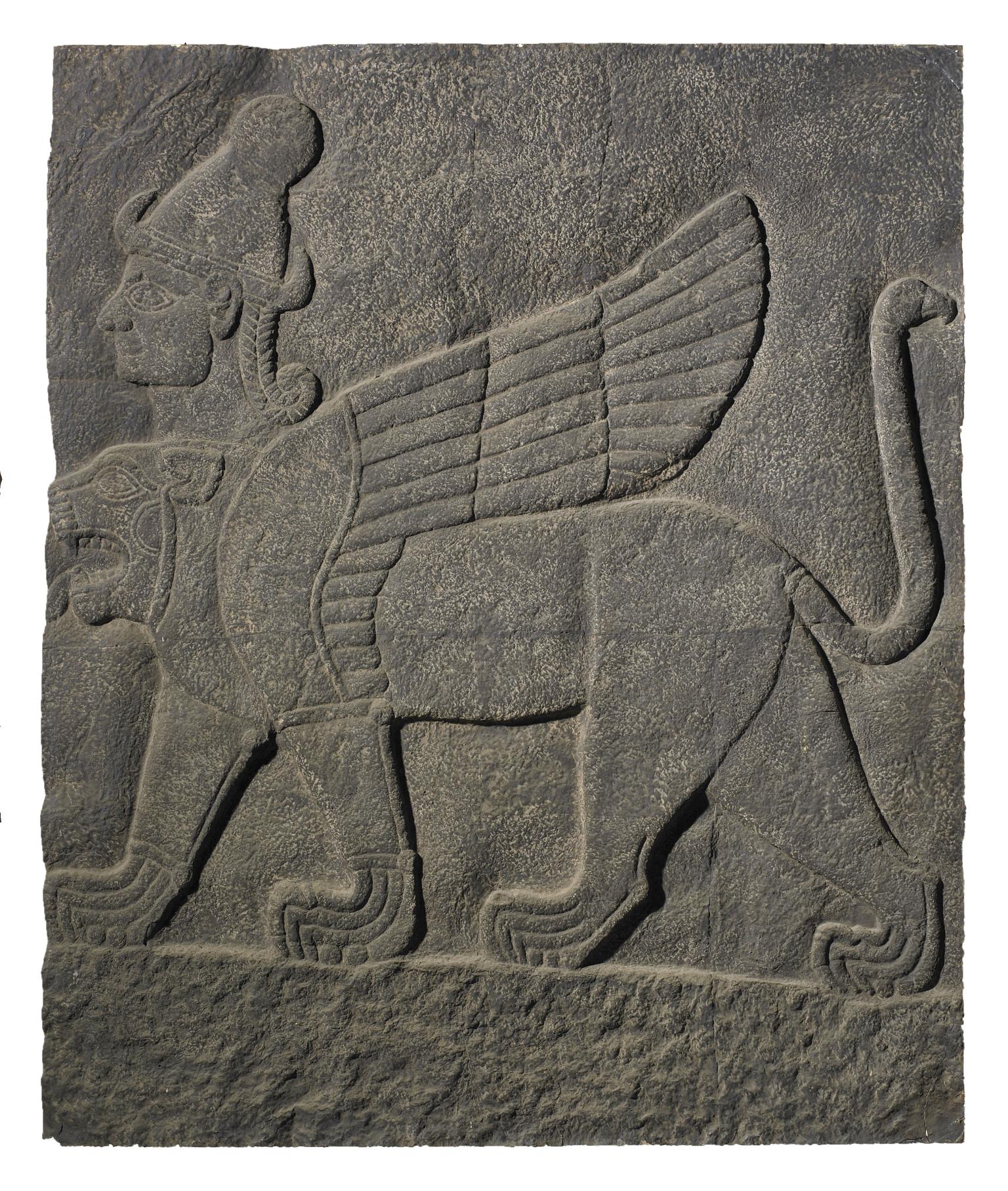 Stone relief of winged lion-like figure with extra head wearing headdress.