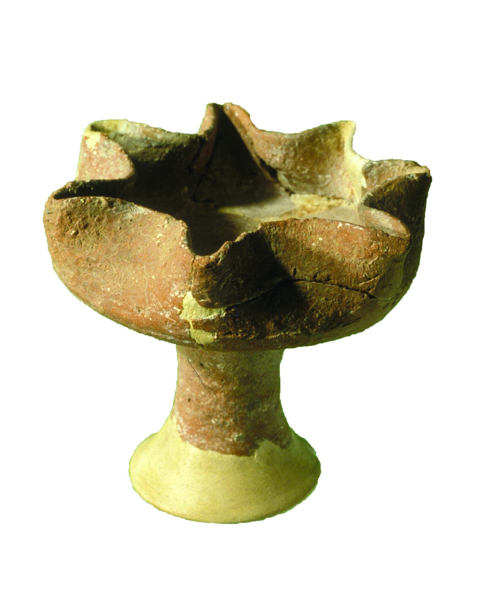 Ceramic oil lamp with seven spouts on a pedestal.