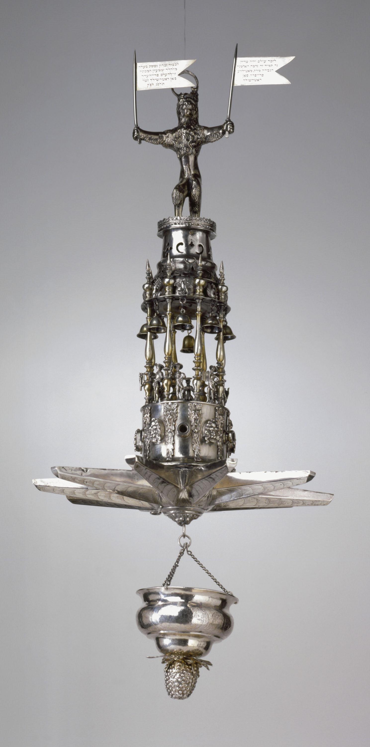 Silver multi-tiered hanging lamp with sculpture of lion on top. 