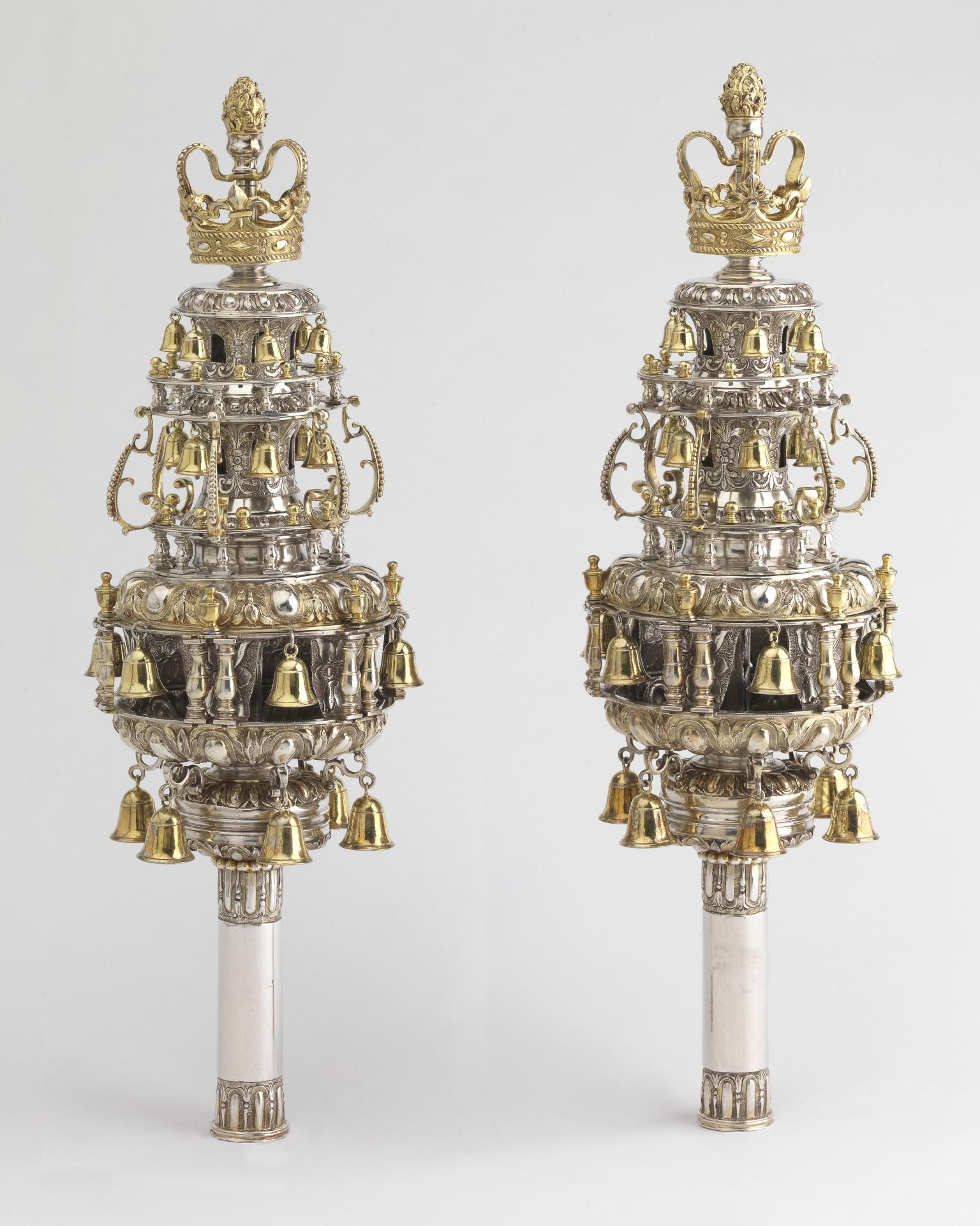 Finials with many layers of branches with bells and topped with crowns.