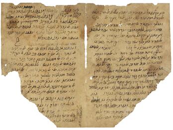 Damaged and torn parchment with Hebrew and Arabic writing in various sizes and orientations.